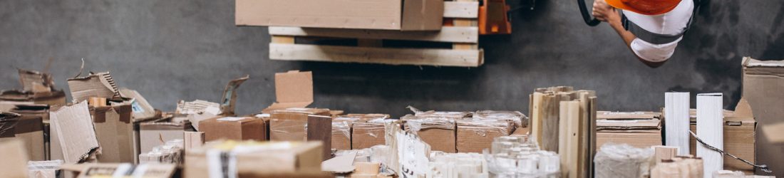 Young man working at a warehouse with boxes